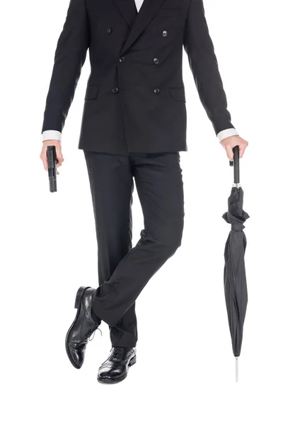 Cropped view of secret agent holding handgun and umbrella, isolated on white — Stock Photo