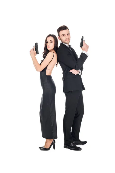 Couple of secret agents posing with weapon, isolated on white — Stock Photo