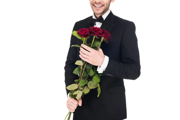 Vista cortada do homem em terno preto segurando rosas vermelhas para o dia dos namorados, isolado no branco — Fotografia de Stock