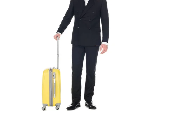 Cropped view of man in black tuxedo posing with travel bag isolated on white — Stock Photo