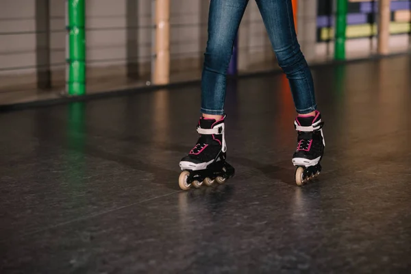 Cropped view of child practicing on roller rink — Stock Photo