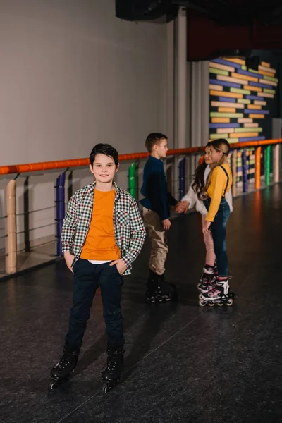 Preteen kids having fun together on roller rink — Stock Photo