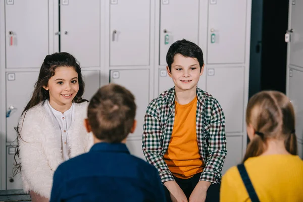 Group of children talking in changing room — Stock Photo