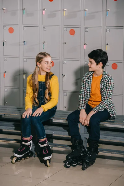 Roller skaters chatting while sitting in changing room — Stock Photo