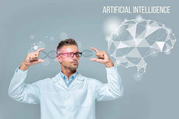 Handsome scientist in glasses holding medical interface with dna and brain isolated on grey, artificial intelligence concept — Stock Photo