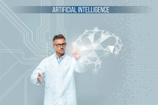 Handsome scientist in glasses touching brain interface isolated on grey, artificial intelligence concept — Stock Photo