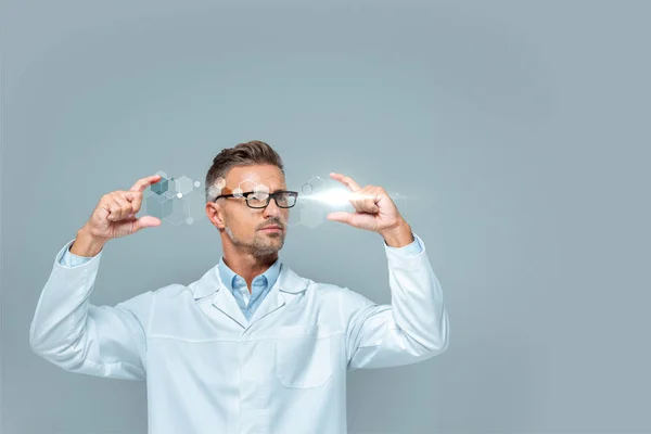 Handsome scientist in glasses holding medical interface isolated on grey, artificial intelligence concept — Stock Photo