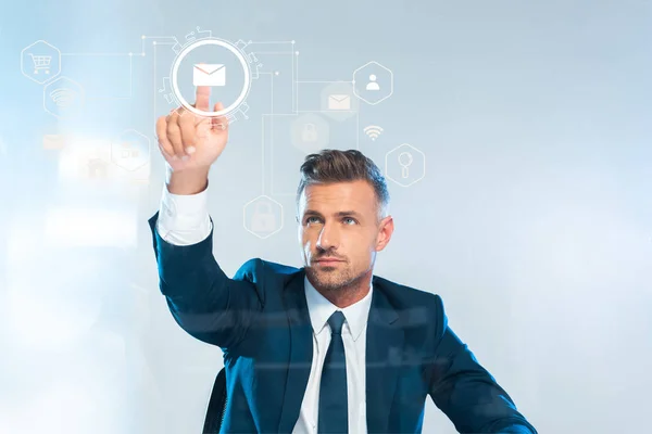 Handsome businessman pointing on male icon isolated on white, artificial intelligence concept — Stock Photo