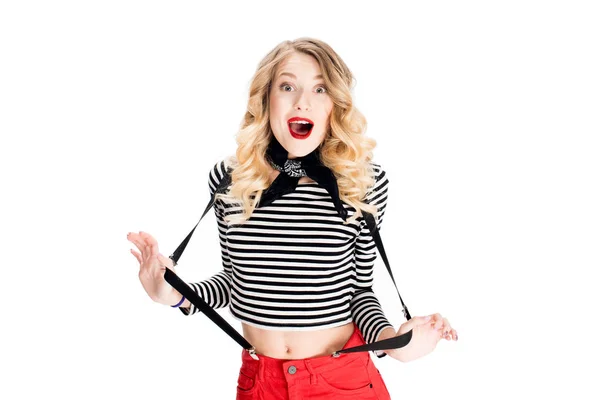 Surprised french woman with blonde hair holding suspenders isolated on white — Stock Photo