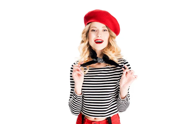 Smiling woman in red hat holding scarf isolated on white — Stock Photo