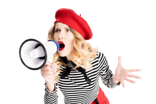 Angry woman in red beret yelling in megaphone isolated on white — Stock Photo