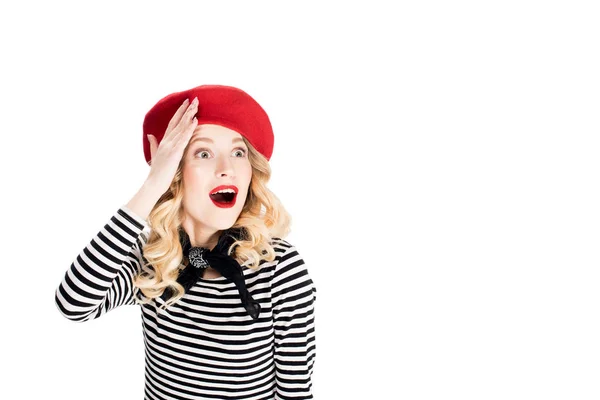 Surprised woman in red beret holding hand on head isolated on white — Stock Photo