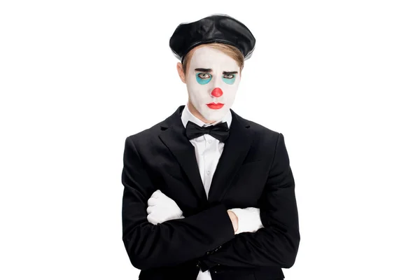 Upset clown in suit and black beret standing with crossed arms isolated on white — Stock Photo