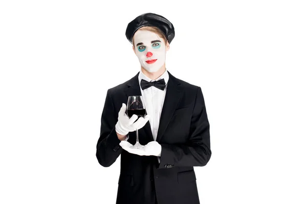 Smiling clown standing in suit and holding glass of wine isolated on white — Stock Photo