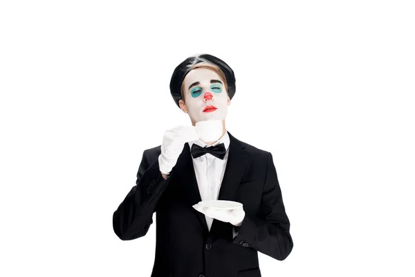 Clown standing in suit and smelling cup of coffee isolated on white — Stock Photo