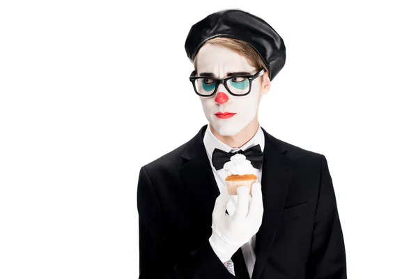 Clown en costume et verres tenant cupcake savoureux isolé sur blanc — Photo de stock