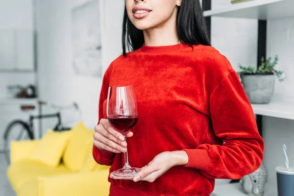 Partial view of african american woman holding glass of wine — Stock Photo
