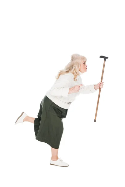 Senior woman running with walking cane isolated on white — Stock Photo