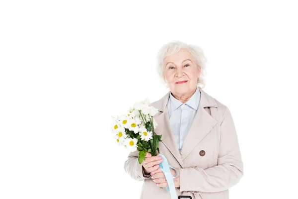 Happy senior woman holding flowers in hands isolated on white — Stock Photo