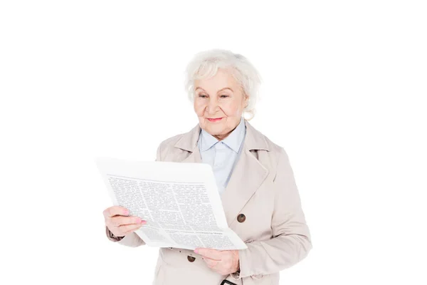 Cheerful senior woman reading newspaper isolated on white — Stock Photo
