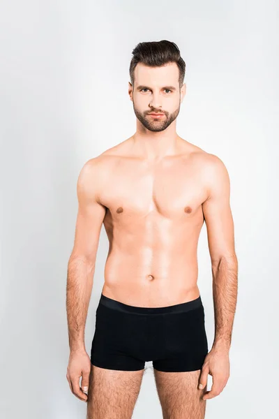 Handsome bearded man posing in boxer shorts isolated on grey — Stock Photo