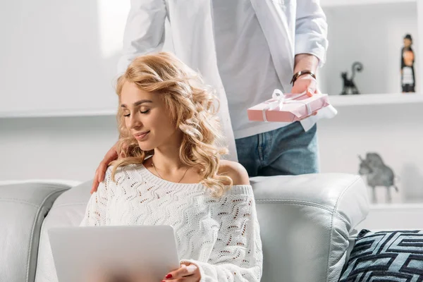 Partial view of man presenting gift to girlfriend — Stock Photo