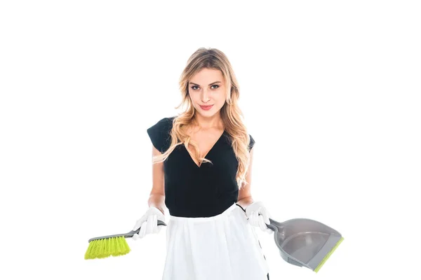 Housemaid in black uniform and apron with broom and scoop isolated on white — Stock Photo