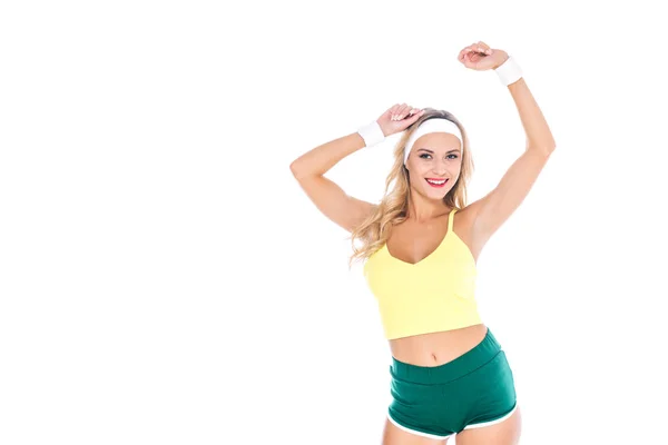 Attraktive blonde Fitnesstrainerin in grüner und gelber Sportbekleidung isoliert auf weiß — Stockfoto