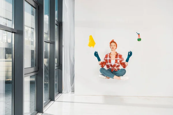 Floating girl in jeans and plaid shirt meditating with rag and spray on white background — Stock Photo