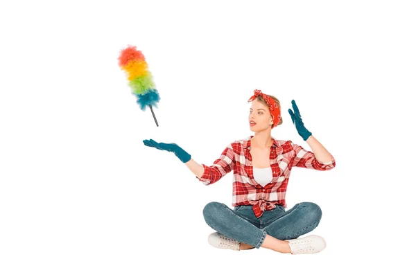 Floating girl in jeans and plaid shirt with duster isolated on white — Stock Photo