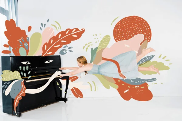 Иллюстрация плавающей девушки в синем платье, играющей на черном пианино — стоковое фото