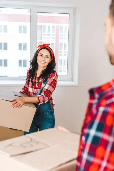 Selektiver Fokus der fröhlichen Frau, die ihren Freund beim Halten der Schachtel ansieht — Stockfoto