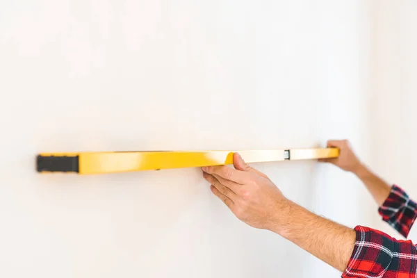 Cropped view of man measuring wall at home — Stock Photo