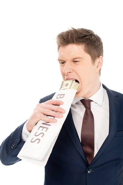 Young businessman biting dollar banknotes wrapped in business newspaper, isolated on white — Stock Photo