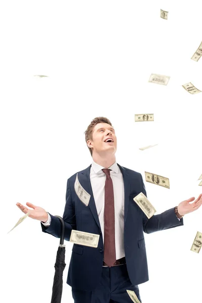 Successful young businessman with falling dollars isolated on white — Stock Photo