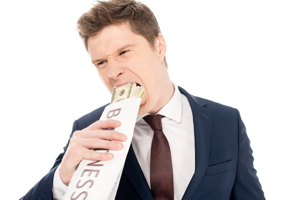 Empresário mordendo dólares embrulhados em jornal de negócios, isolado em branco — Fotografia de Stock