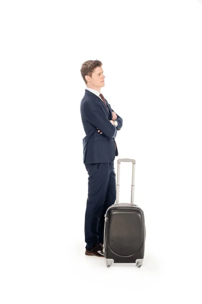 Joven hombre de negocios en traje con maleta para viaje de negocios, aislado en blanco - foto de stock
