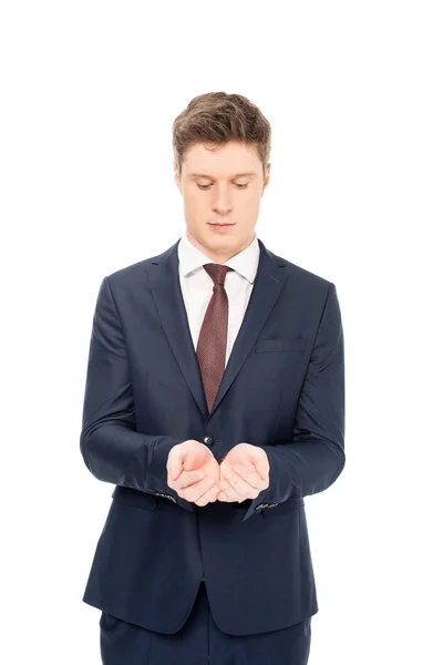 Giovane uomo d'affari in possesso di qualcosa in palme isolato su bianco — Foto stock