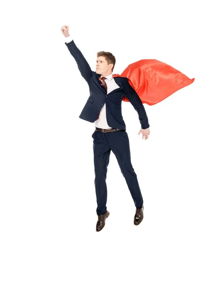 Super businessman flying in suit and red cloak isolated on white — Stock Photo