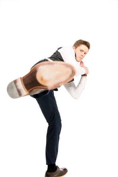Selective focus of young businessman making kick isolated on white — Stock Photo