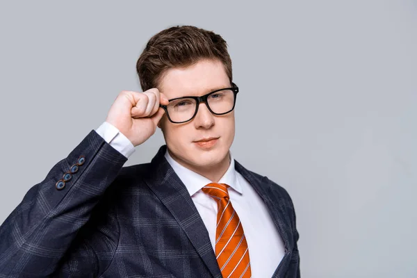 Stylish successful businessman in eyeglasses isolated on grey — Stock Photo