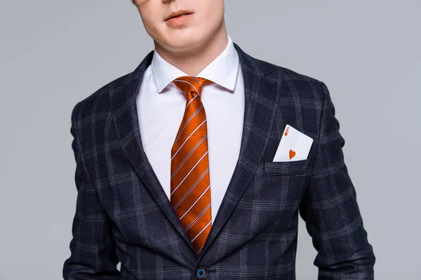 Cropped view of stylish businessman with ace in pocket isolated on grey — Stock Photo
