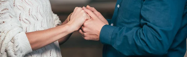 Cropped view of wife and husband holding hands — Stock Photo