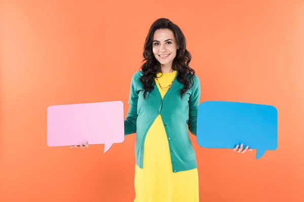 Charming pregnant woman holding speech bubbles isolated on orange — Stock Photo