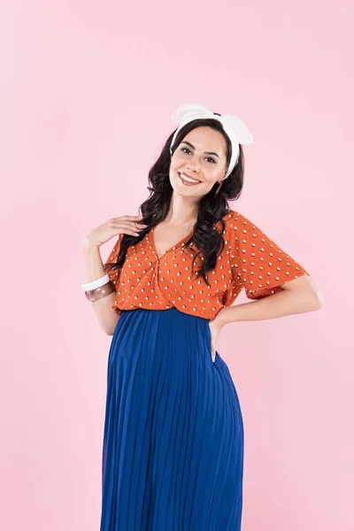 Stylish brunette pregnant woman in blue skirt isolated on pink — Stock Photo