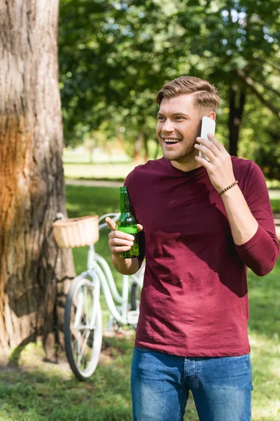 Cheerful man talking on smartphone while talking on smartphone — Stock Photo