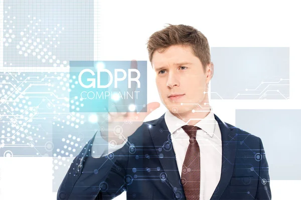 Successful businessman in suit pointing with finger at gdpr compliant illustration on white background — Stock Photo