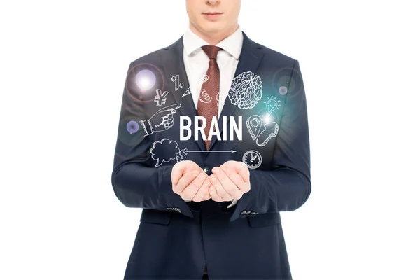 Vista recortada de hombre de negocios en traje con las manos extendidas y las letras del cerebro y los iconos por encima aislado en blanco - foto de stock