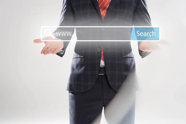 Cropped view of businessman in suit pointing with hands at search bar illustration in front — Stock Photo