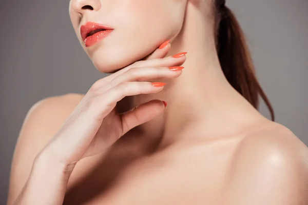 Cropped view of nude woman touching face and posing isolated on grey — Stock Photo